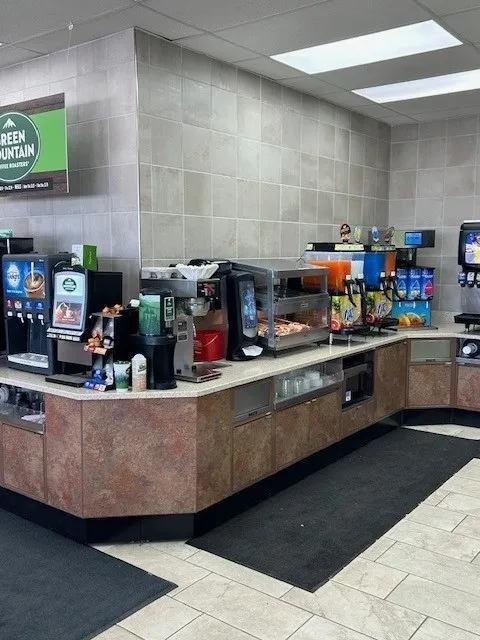 A large counter with many different drinks on it.