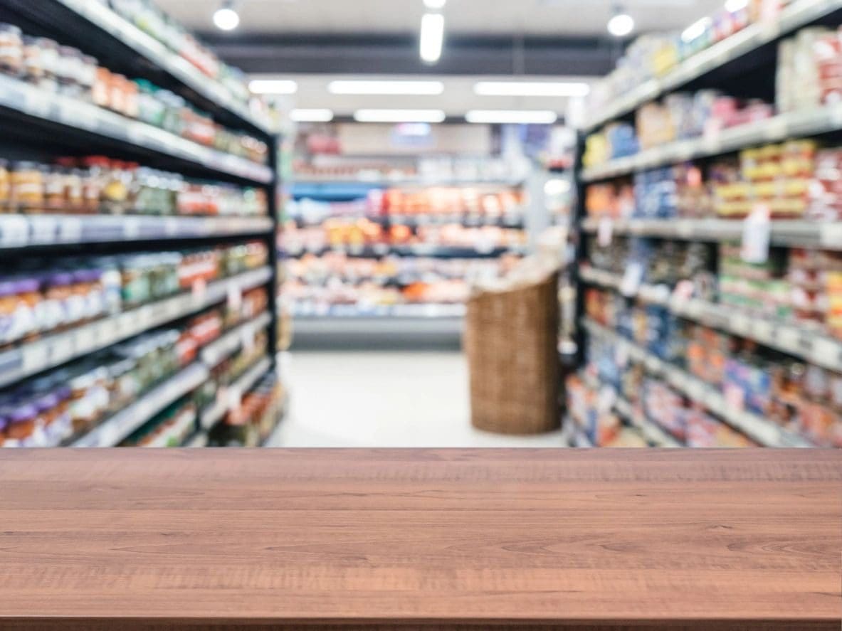 A wooden table in front of an aisle.