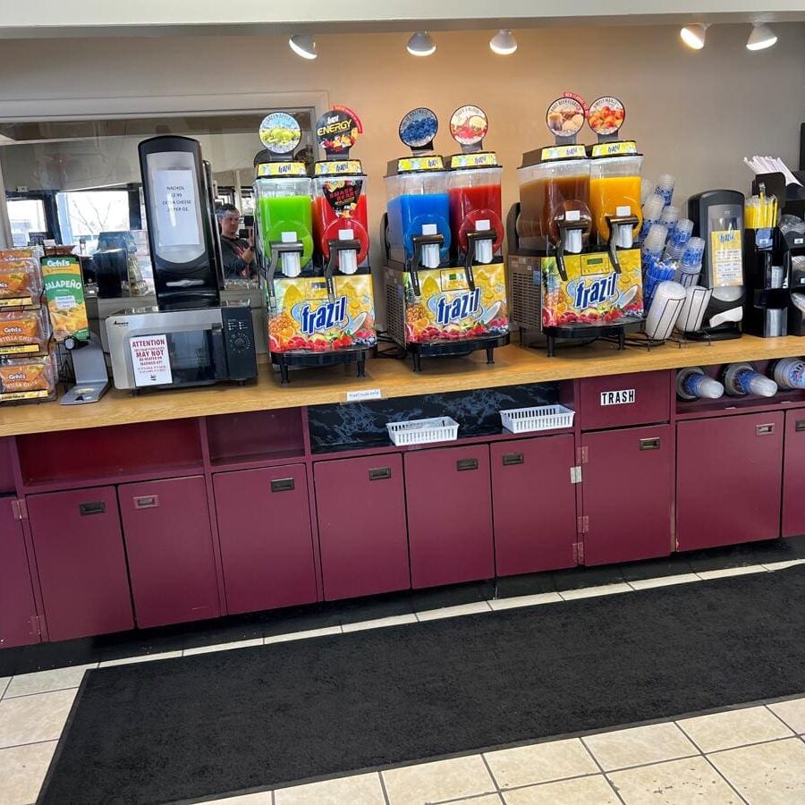 A large counter with many drinks on top of it.