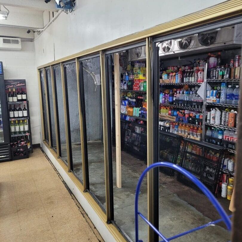 A store with many refrigerators and shelves of beverages.