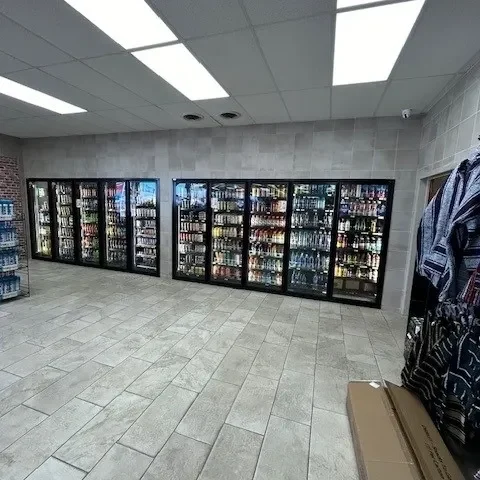 A store with many refrigerators and shelves of food.