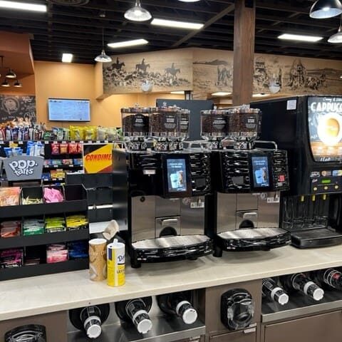 A coffee shop with many machines and shelves.