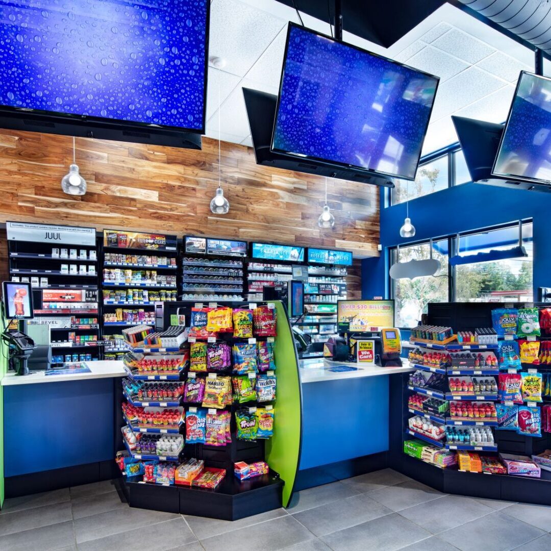 A store with many items on display and two tvs above.