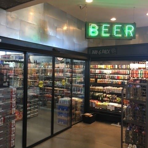 A beer store with lots of shelves filled with beers.