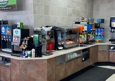 A large counter with many different drinks on it.