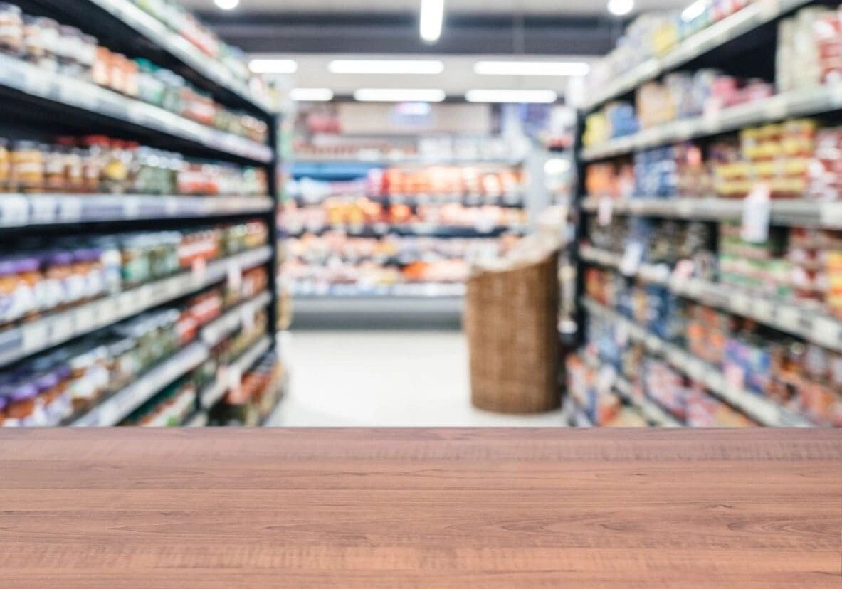 A wooden table in front of an aisle.